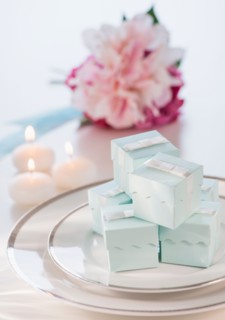 Pastel composition with gifts packages, candles and flowers