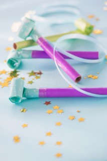 Studio shot of party blowers and confetti