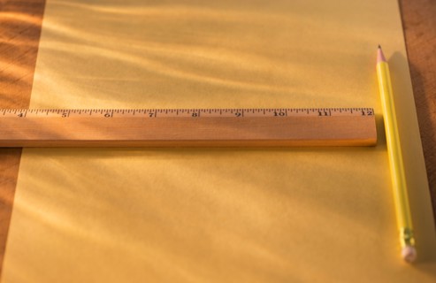 Elevated view of ruler, pencil and paper sheet