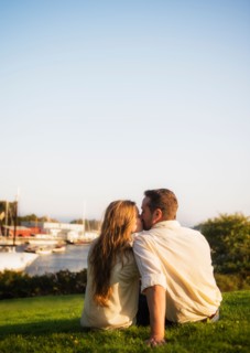 Couple kissing, harbor in background