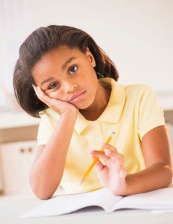 Bored girl (6-7) doing homework