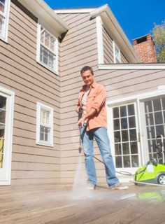 Portrait of man cleaning porch