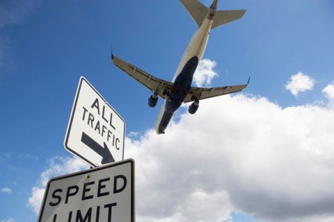 Airplane flying above road signs