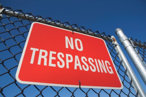 Low angle view of no trespassing sign