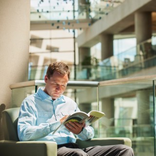 Portrait of man reading in armchair