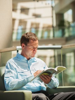 Portrait of man reading in armchair