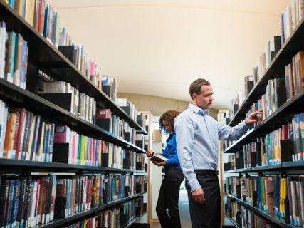 View of man and woman researching library