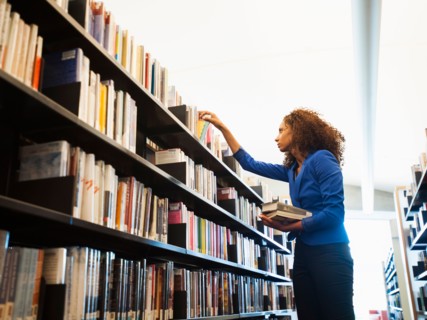 Young woman researching library