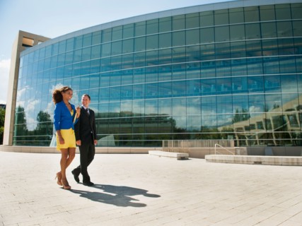 Man and woman walking outside office building