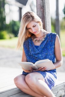 Portrait of woman reading book outdoors