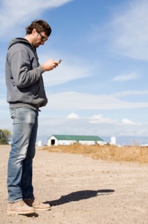Farmer looking at cell phone