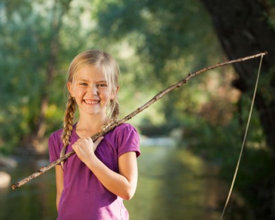 Little girl (4-5) holding wooden stick fishing pole