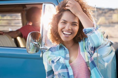 Woman in foreground with friend during their road trip