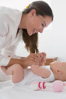 Smiling mother and baby daughter (6-11 months)