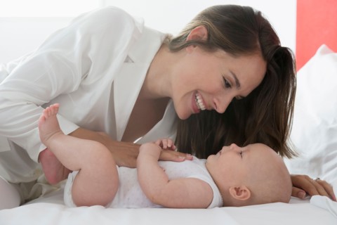 Smiling mother and baby daughter (6-11 months)