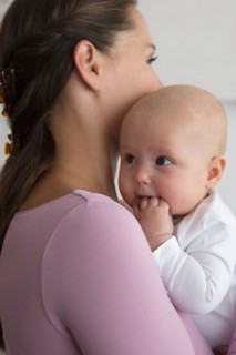 Mother holding baby daughter (6-11 months)