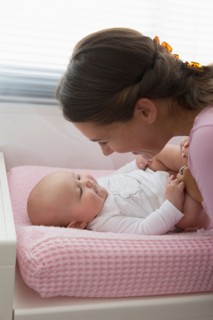 Mother playing with baby daughter (6-11 months)