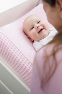 Mother playing with baby daughter (6-11 months)