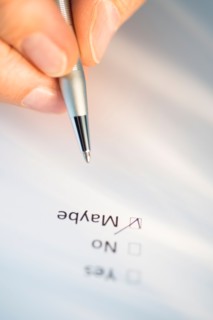 Close-up of hand filling out form.
