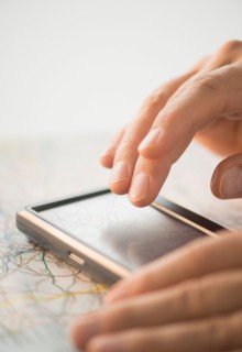 Close-up of hand using gps system.