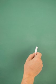 Hand writing on chalkboard.