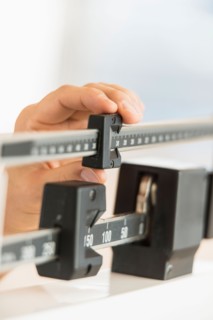 Hand adjusting weight scales.