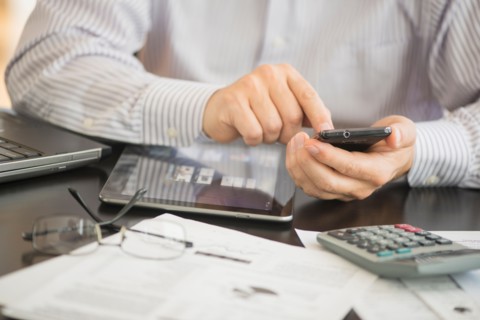 Man using tablet pc, laptop and smartphone.