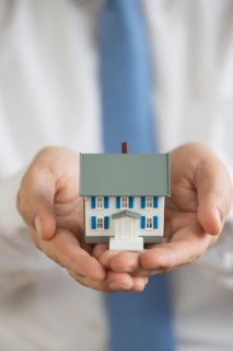 Man holding model house.