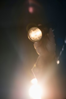 Hand holding flashlight.