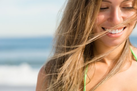 Beautiful woman at beach. Photo : Jamie Grill