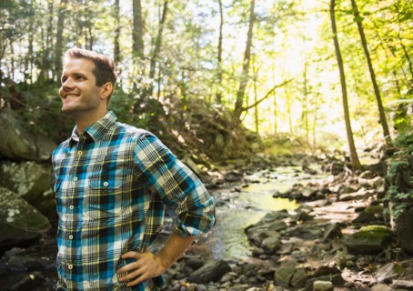 Man standing in forest. Photo : Jamie Grill