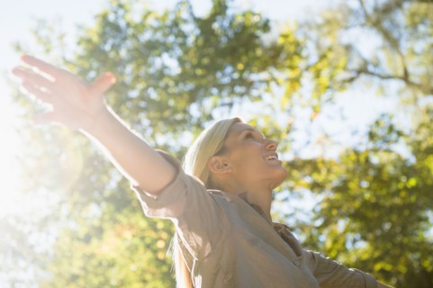 Happy woman outdoors. Photo: Jamie Grill