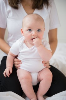 baby boy (2-5 months) held by mother. Photo: Jamie Grill
