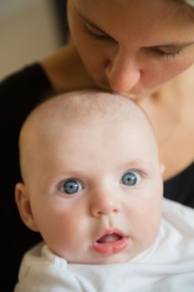 Mother kissing baby boy (2-5 months). Photo: Jamie Grill