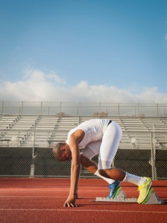 Boy (12-13) preparing for running on starting line. Photo: Erik Isakson