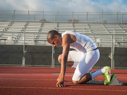 Boy (12-13) preparing for running on starting line. Photo: Erik Isakson