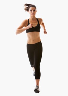 Young woman running, studio shot. Photo : Mike Kemp