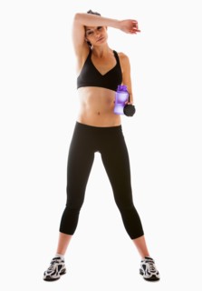 Young woman resting after exercising, studio shot. Photo : Mike Kemp