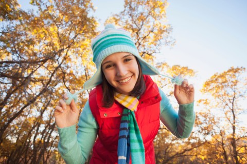 Portrait of smiling young woman in autumn forest. Photo: Mike Kemp
