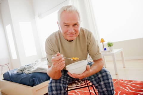 Senior man eating cereal from bowl. Photo: Rob Lewine