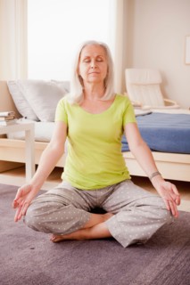 Senior woman practicing yoga. Photo : Rob Lewine