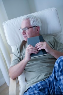 Portrait of senior man holding book. Photo: Rob Lewine