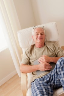 Senior man taking nap and holding book. Photo: Rob Lewine