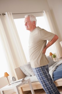 Senior man having backpain. Photo : Rob Lewine