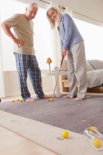 Senior couple playing mini golf at home. Photo: Rob Lewine