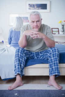 Senior couple after quarrel sitting on bed. Photo : Rob Lewine