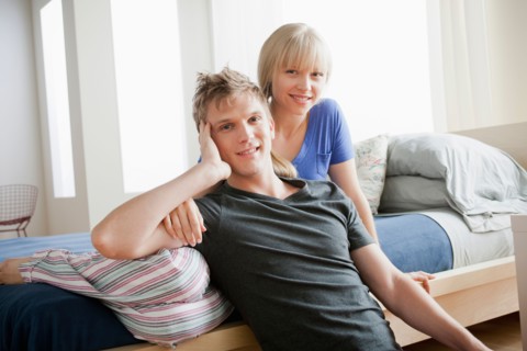 Portrait of couple in bedroom. Photo : Rob Lewine