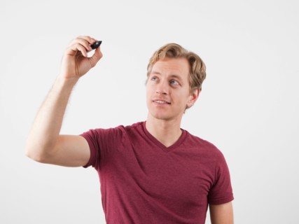 Portrait of man holding marker, ready to write. Photo : Jessica Peterson