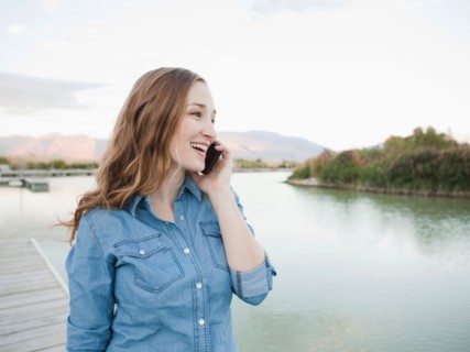 Portrait of young woman talking on phone. Photo : Jessica Peterson