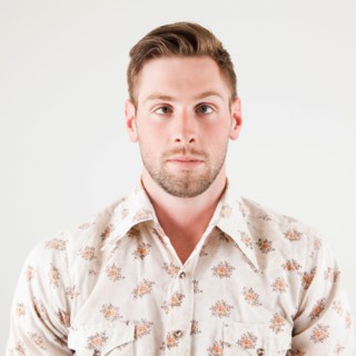 Studio portrait of cross-eyed man. Photo : Jessica Peterson